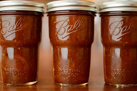 Another image of the three Ball Nesting Jars of chutney lined up in a row, sitting on a wooden table.