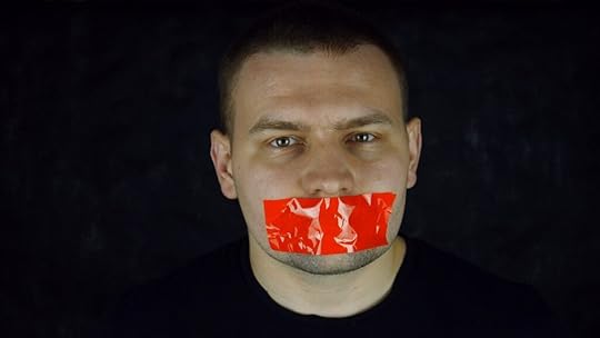 Man's face with red tape across mouth