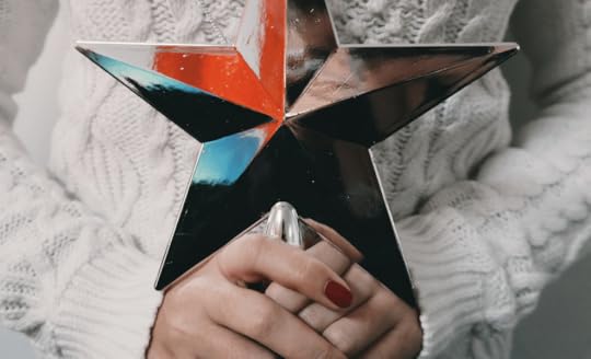woman holding star tree topper