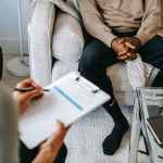 crop ethnic client discussing problems with anonymous psychologist