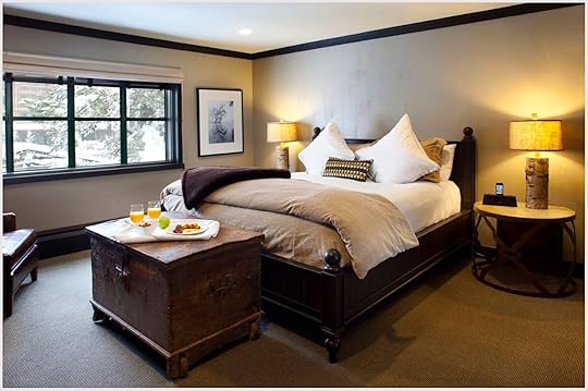 A cozy bedroom with a large bed at Plump Jack Inn, a popular hotel near Lake Tahoe