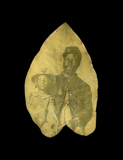 Studio portrait of a Black Union soldier in uniform, gazing at camers while ? at his side.