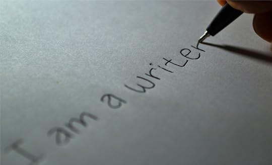 The words 'I am a writer' written on paper.
