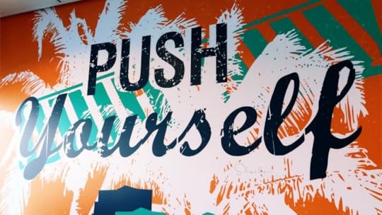 painted wall sign push yourself for wellness like with Peloton