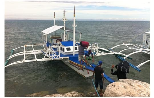 Our backpacks being carried onto the boat over to Malapascua Island