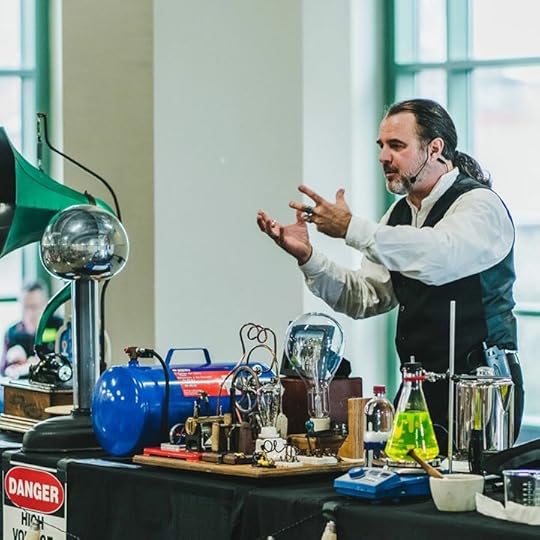 Daniel explains an electrical experiment during a science show.
