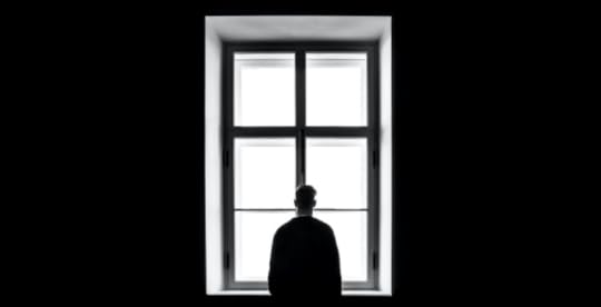 Lonely man looking out a window