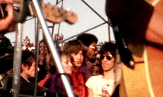 Crowd of people at side of stage on a sunny day