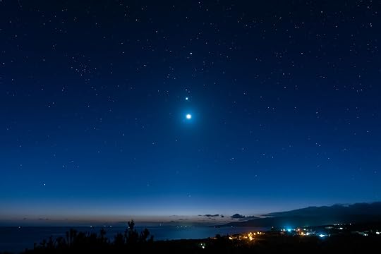 Breathtaking view of a starry sky, Venus, Jupiter and moon line up. Top view of a seashore city before dawn. Iriomote Island, natural world heritage.