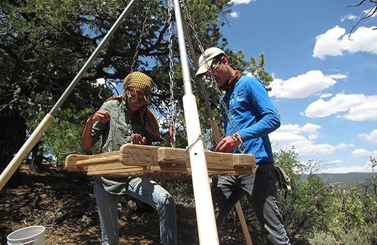Two young people looking through soil at an archeological dig in New Mexico