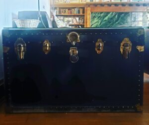 black steamer trunk front with grass locks