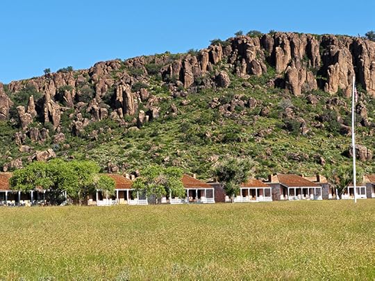 A long shot of another row of bungalow-style houses that served as officers' quarters with Sleeping Mountain in the background at Fort Davis National Historic Site.
