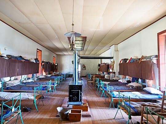 Interior photo of furnished barracks. There were dozens of buildings for the barracks like this one; the whole site is full of old foundations