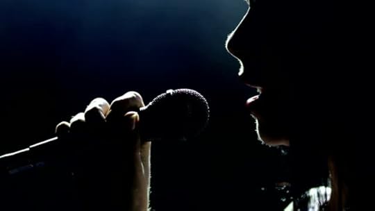 https://media.istockphoto.com/videos/female-singer-on-the-stage-holding-a-microphone-video-id1006365154?s=640x640