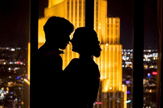 Couple outline with sky scrapper lit in background