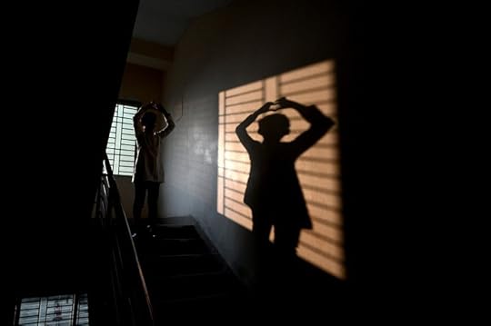 woman's shadow project onto wall
