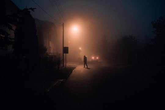 person walking in the snow at night