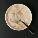 overhead shot of a bowl of chipotle mayo with a spoon swirling it.