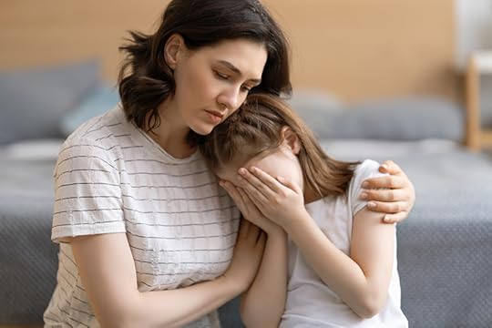 A mother comforts her sad daughter. The daughter covers her face with her hands while her mother holds her. When a child exhibits an unexpected change in their behavior, it's time to look beneath the surface of a child's behavior.