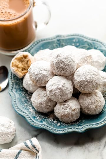 mini powdered sugar donut muffins piled on blue plate