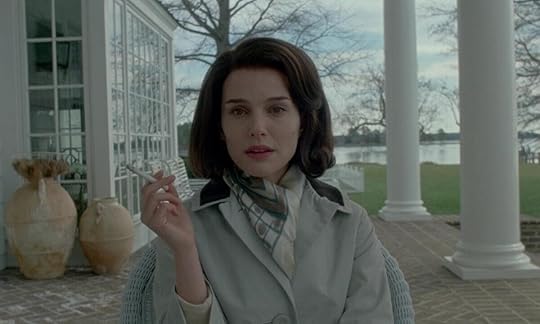 Natalie Portman as Jacqueline Kennedy Onassis in Pablo Larraín’s Jackie (2016). She is smoking on a verandah in a tan jacket and white scarf.