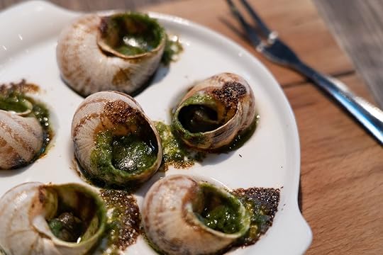 Escargots de Bourgogne or Snails with garlic herbs butter on the wooden table