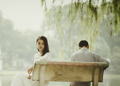 couple sitting with backs turned to each other