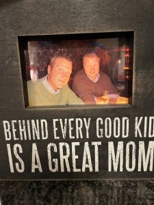 A picture frame with two boys as it's photo.