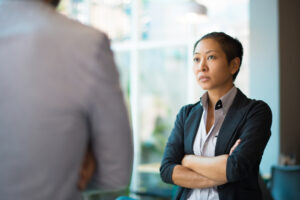 Person with arms crossed looking unhappy