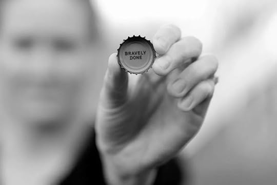 Image: Hand holding a bottle cap with 
