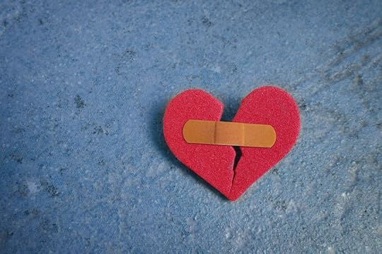 Image: a red heart-shaped piece of foam, torn in two down the middle and held together with a Band-Aid.