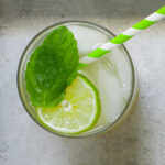 overhead shot of mojito mocktail on silver tray.
