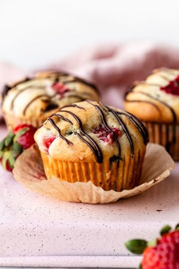 strawberry and chocolate chip muffins with chocolate drizzle on top