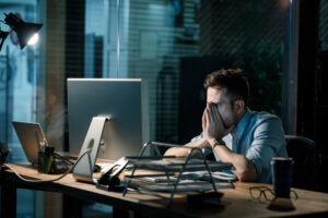Person working late a night looking exhausted