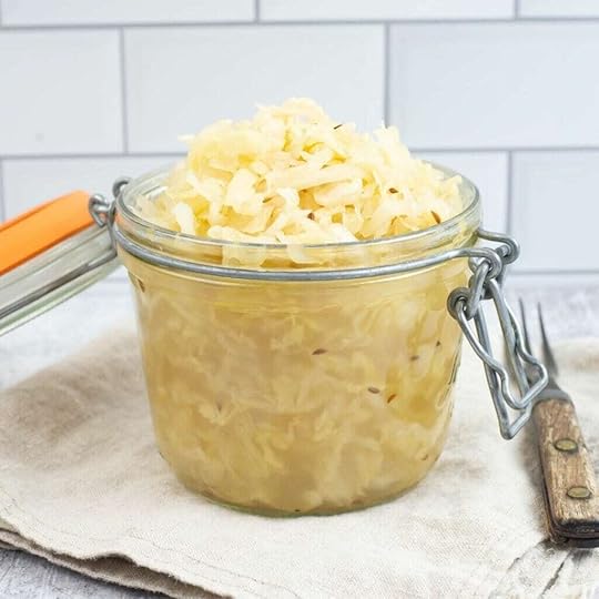 A glass jar filled with fermented sauerkraut..