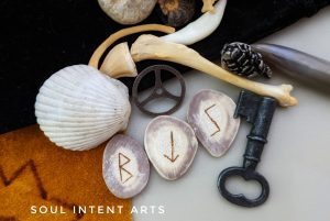 Elder Futhark reindeer antler runes Sowilo, Tiwaz reversed, then Berkana, with various bones and an old key on a multi-colored background