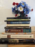 stack of books with flowers in the background