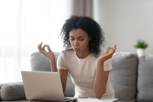 Person working on laptop and breathing through stress
