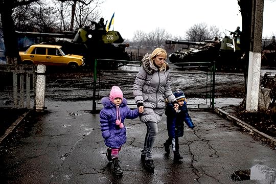 March 2015: Civilians pass by as OSCE monitors the movement of heavy weaponry in eastern Ukraine. (OSCE, CC BY-NC-ND 2.0)