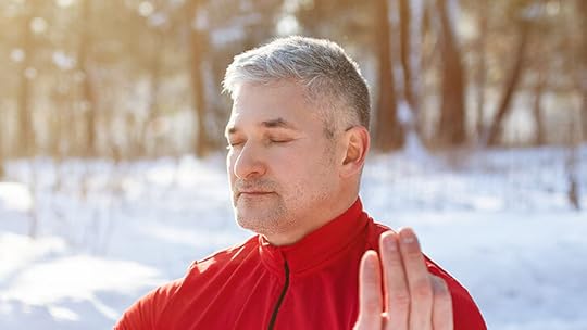 older man meditating in snow