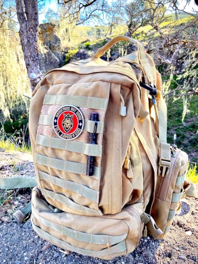 A military style backpack with a patch on it which says