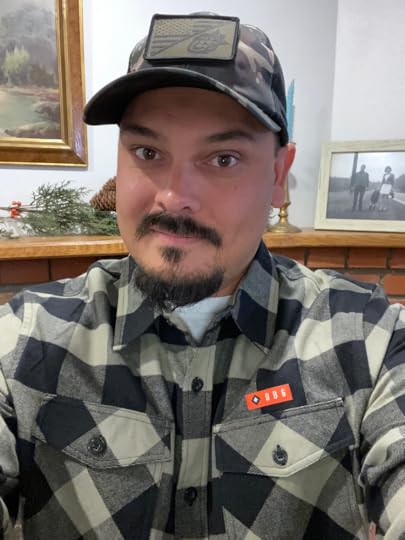A camo hat with a picture of the American flag and the lion of the tribe of Judah, as well as a botton up shirt from Christian clothing company Dangerous but Good.