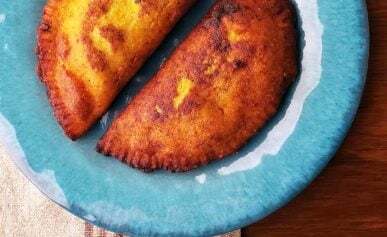 Two shrimp empanadas on a plate.