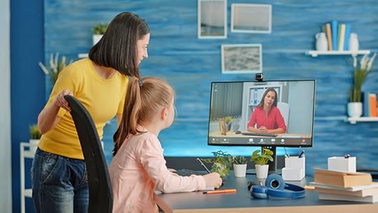 A student and her mother interact with a teacher on their computer monitor at home. Virtual learning presents a unique challenging teaching situation.