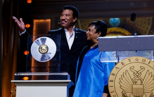 An onstage photo of Lionel Richie and Carla Hayden 