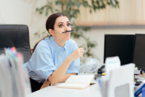 women balancing a pen on her upper lip