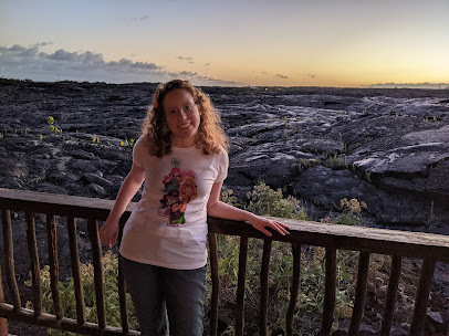 The Princess Blogger posing in front of the sunset over a field of hardened lava