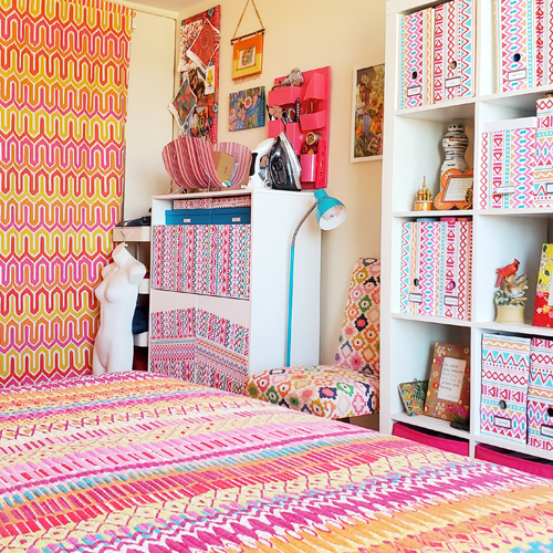 bright, bohemian chic bedroom with custom curtains replacing closet doors