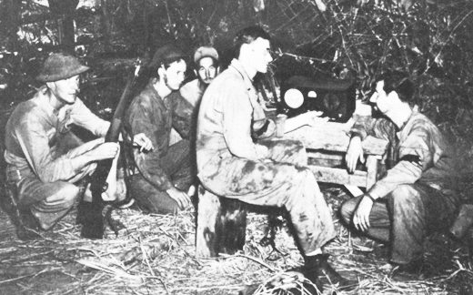 US soldiers listening to radio broadcast on Bataan Peninsula, 1942 (US Army Center for Military History)