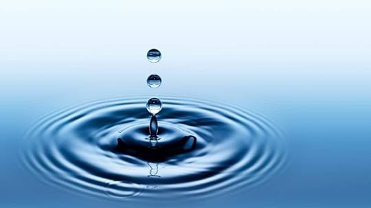 water drop landing in water showing a nudge creating rings
